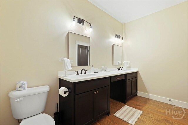 39 Bird Dog Ln, Midway, GA 31320 - bathroom with double vanity, wood finished floors, toilet, and baseboards