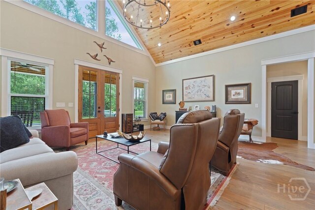 39 Bird Dog Ln, Midway, GA 31320 - living room with light wood-type flooring, high vaulted ceiling, a chandelier, recessed lighting, and french doors