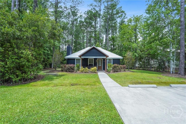 152 Covey Rise Pl, Midway, GA 31320 - ranch-style home featuring a front yard, a chimney, and metal roof