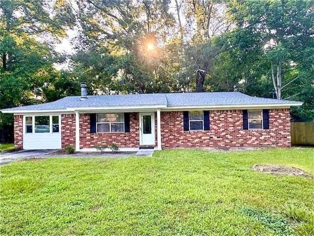 309 Middleton St S, Pooler, GA 31322 - ranch-style home featuring a front yard, view of wooded area, and brick siding