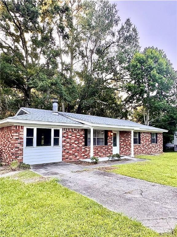 309 Middleton St S, Pooler, GA 31322 - single story home featuring brick siding, a front yard, and a chimney
