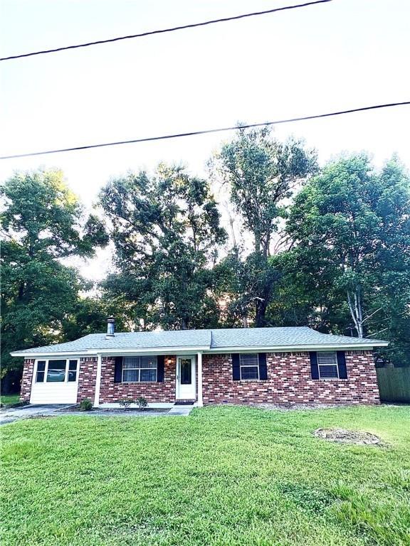 309 Middleton St S, Pooler, GA 31322 - ranch-style home with a front lawn, brick siding, and view of wooded area