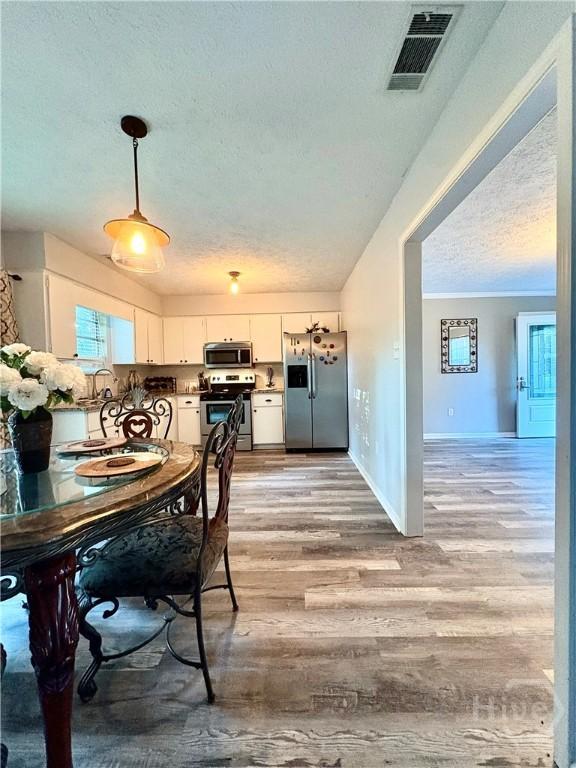 309 Middleton St S, Pooler, GA 31322 - dining room with a textured ceiling and light wood-style flooring