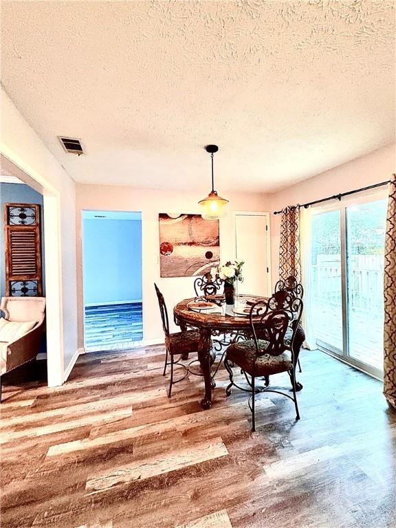 309 Middleton St S, Pooler, GA 31322 - dining space with a textured ceiling, wood finished floors, and baseboards