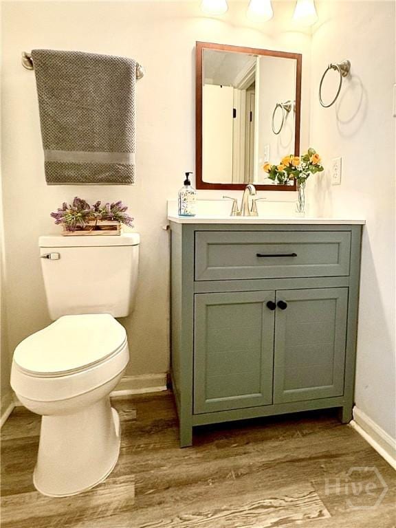 309 Middleton St S, Pooler, GA 31322 - half bathroom featuring baseboards, vanity, wood finished floors, and toilet
