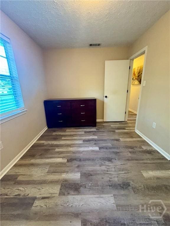 309 Middleton St S, Pooler, GA 31322 - empty room with wood finished floors, a textured ceiling, and baseboards