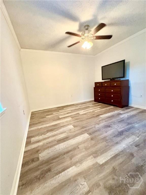 309 Middleton St S, Pooler, GA 31322 - unfurnished bedroom with wood finished floors, a textured ceiling, baseboards, ornamental molding, and a ceiling fan
