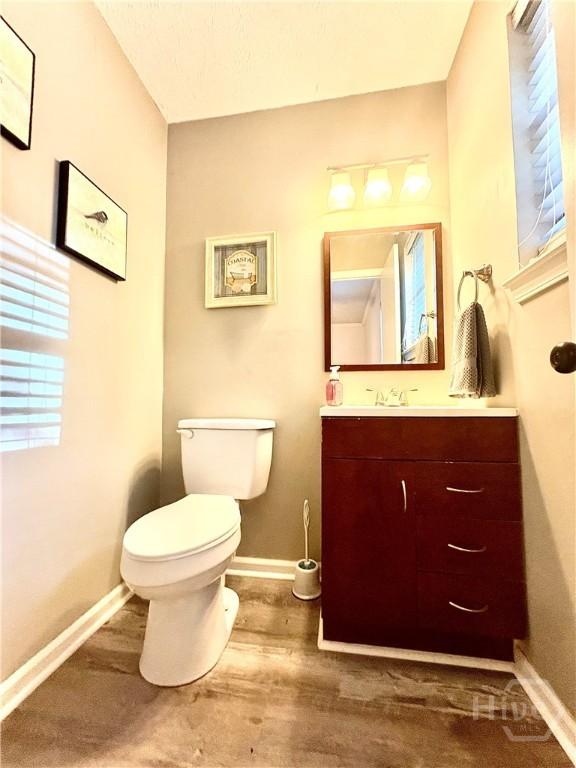 309 Middleton St S, Pooler, GA 31322 - bathroom featuring toilet, baseboards, vanity, and wood finished floors