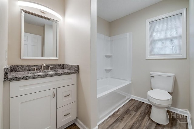 405 E 3rd St, Springfield, GA 31329 - full bath featuring wood finished floors, vanity, toilet, baseboards, and shower / bath combination