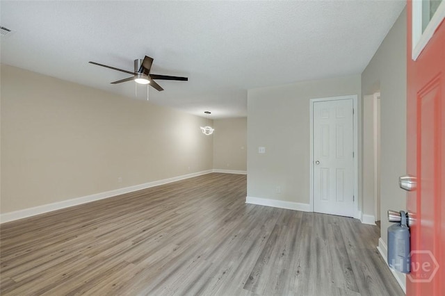 405 E 3rd St, Springfield, GA 31329 - unfurnished room with wood finished floors, a ceiling fan, baseboards, and a chandelier