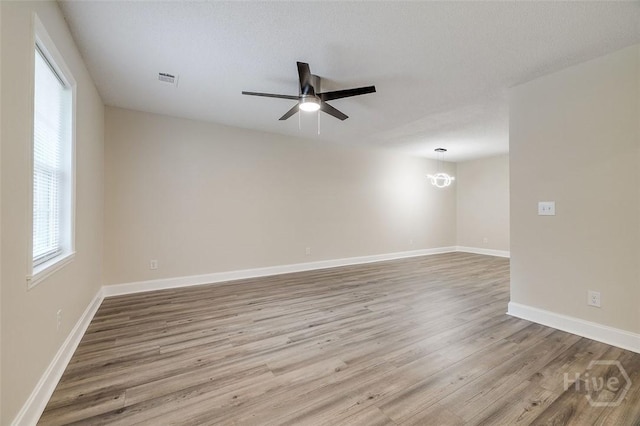 405 E 3rd St, Springfield, GA 31329 - empty room with wood finished floors, ceiling fan, and baseboards