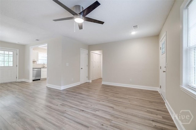 405 E 3rd St, Springfield, GA 31329 - unfurnished living room featuring a ceiling fan, light wood-style floors, baseboards, and a sink