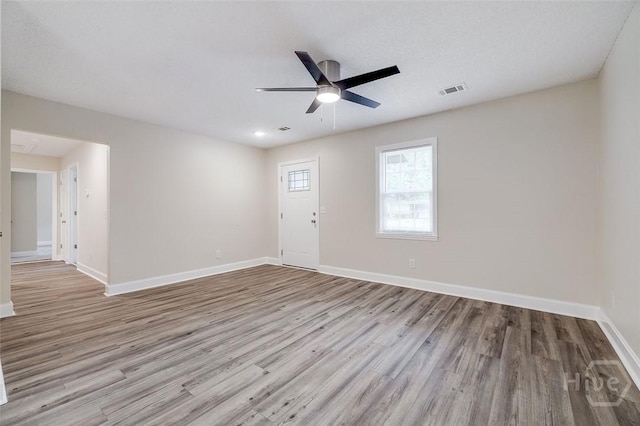 405 E 3rd St, Springfield, GA 31329 - unfurnished room with wood finished floors, ceiling fan, and baseboards