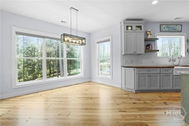206 Captain Cone Ct, Brooklet, GA 30415 - kitchen featuring gray cabinets, open shelves, light wood finished floors, a chandelier, and recessed lighting
