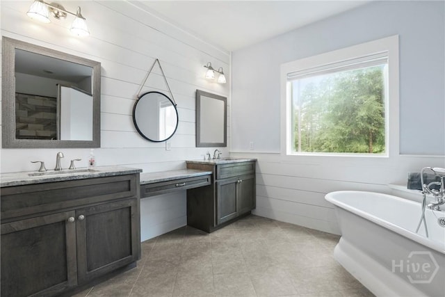 206 Captain Cone Ct, Brooklet, GA 30415 - full bath with double vanity, a freestanding tub, wooden walls, tile patterned floors, and wainscoting