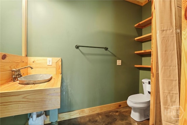 206 Captain Cone Ct, Brooklet, GA 30415 - bathroom featuring toilet, a sink, concrete flooring, and baseboards