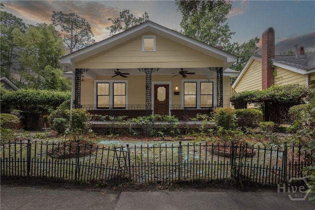 1319 E 39th St E, Savannah, GA 31404 - view of front of property featuring ceiling fan, a fenced front yard, and covered porch