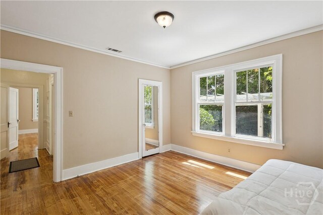 1319 E 39th St E, Savannah, GA 31404 - unfurnished bedroom featuring crown molding and wood finished floors