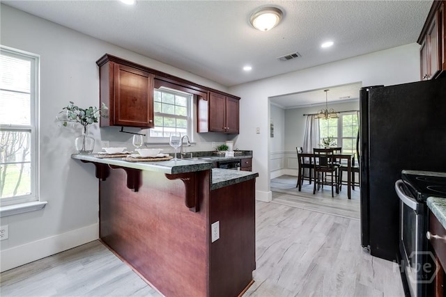 82 Saddlebrush Rd, Ellabell, GA 31308 - kitchen with stainless steel range, a peninsula, healthy amount of natural light, a breakfast bar, and recessed lighting