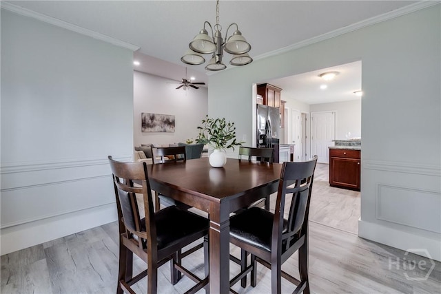 82 Saddlebrush Rd, Ellabell, GA 31308 - dining space featuring a chandelier, ornamental molding, light wood-style flooring, and a ceiling fan