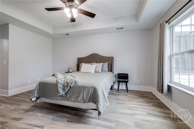 82 Saddlebrush Rd, Ellabell, GA 31308 - bedroom featuring a tray ceiling, multiple windows, crown molding, and baseboards