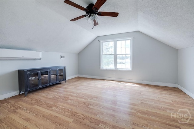 82 Saddlebrush Rd, Ellabell, GA 31308 - additional living space featuring wood finished floors, a wall mounted AC, ceiling fan, lofted ceiling, and a textured ceiling