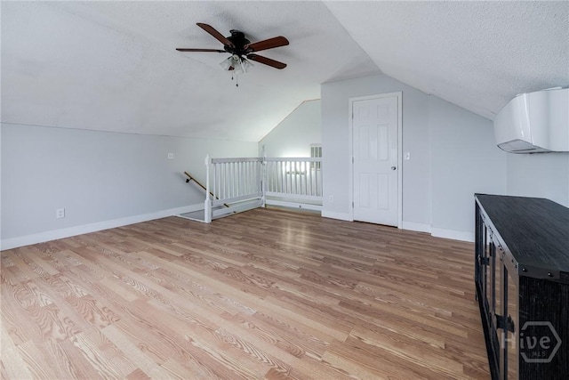 82 Saddlebrush Rd, Ellabell, GA 31308 - bonus room featuring a textured ceiling, vaulted ceiling, light wood-style floors, ceiling fan, and baseboards