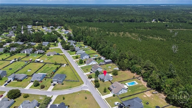 82 Saddlebrush Rd, Ellabell, GA 31308 - aerial view of property and surrounding area featuring a heavily wooded area and nearby suburban area