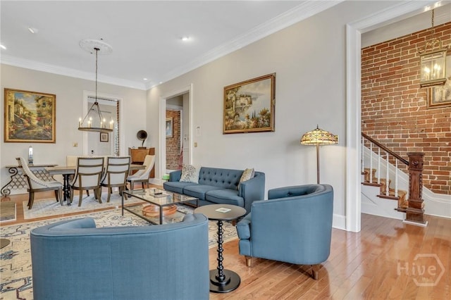509 E Broughton St, Savannah, GA 31401 - living area featuring wood finished floors, stairs, crown molding, a chandelier, and baseboards
