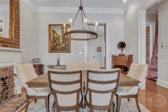 509 E Broughton St, Savannah, GA 31401 - dining space featuring a chandelier, wood finished floors, ornamental molding, recessed lighting, and a fireplace with raised hearth