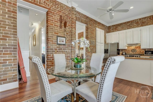 509 E Broughton St, Savannah, GA 31401 - dining area featuring ceiling fan, crown molding, light wood-style flooring, brick wall, and recessed lighting