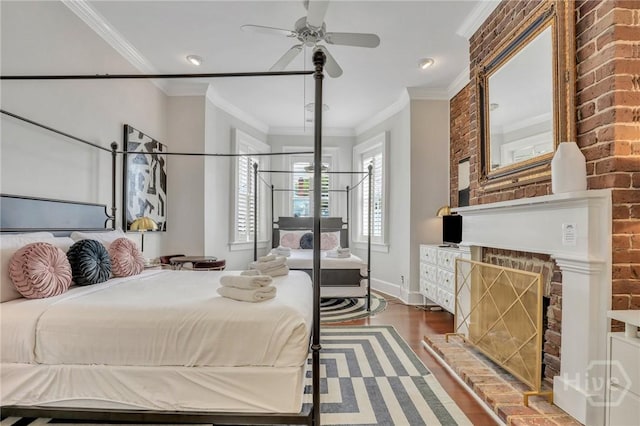 509 E Broughton St, Savannah, GA 31401 - bedroom with wood finished floors, ornamental molding, baseboards, brick wall, and a brick fireplace