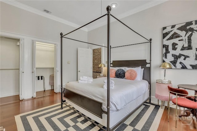 509 E Broughton St, Savannah, GA 31401 - bedroom featuring wood finished floors, ornamental molding, and baseboards