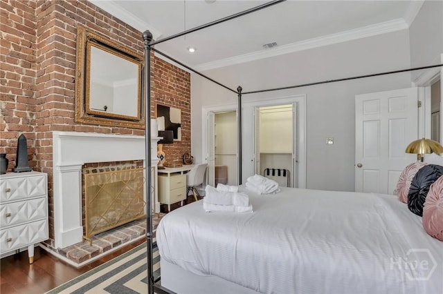 509 E Broughton St, Savannah, GA 31401 - bedroom with ornamental molding, brick wall, wood finished floors, a fireplace, and radiator heating unit