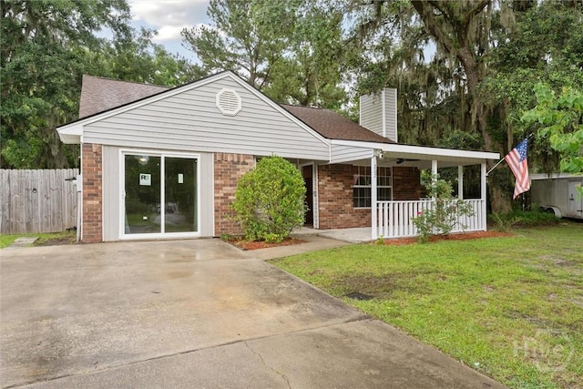 207 Whippoorwill Ln E, Richmond Hill, GA 31324 - ranch-style home with a porch, a chimney, brick siding, and a shingled roof