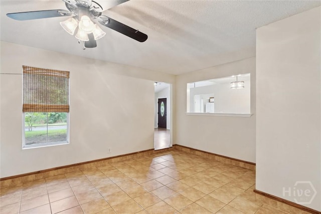 207 Whippoorwill Ln E, Richmond Hill, GA 31324 - unfurnished room featuring a ceiling fan, light tile patterned flooring, baseboards, and a textured ceiling