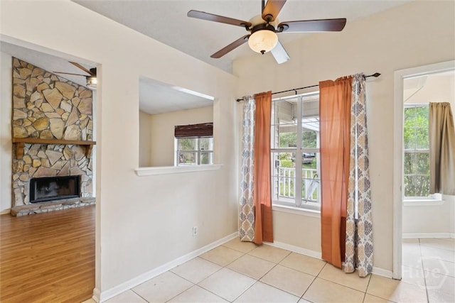 207 Whippoorwill Ln E, Richmond Hill, GA 31324 - entryway with a ceiling fan, a fireplace, baseboards, and tile patterned flooring