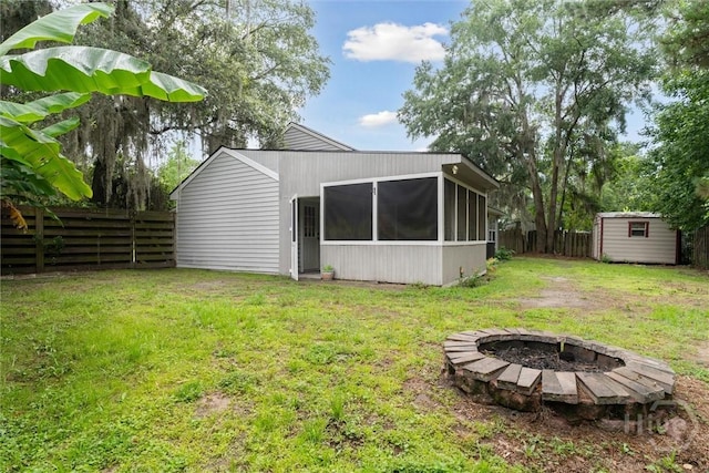 207 Whippoorwill Ln E, Richmond Hill, GA 31324 - view of yard featuring a sunroom and an outdoor fire pit