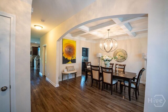 66 Tarbert Cut Cut, Richmond Hill, GA 31324 - dining room featuring arched walkways, wood finished floors, beamed ceiling, a chandelier, and coffered ceiling