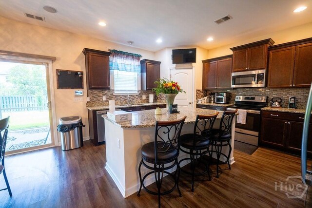 66 Tarbert Cut Cut, Richmond Hill, GA 31324 - kitchen featuring stainless steel appliances, a kitchen island, tasteful backsplash, dark wood-style floors, and recessed lighting