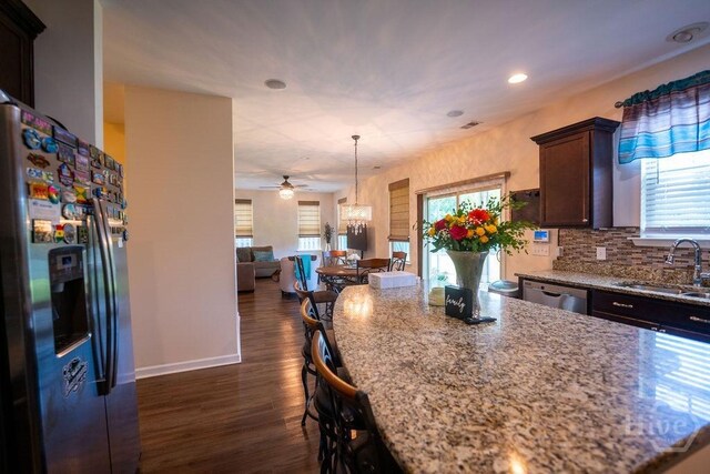 66 Tarbert Cut Cut, Richmond Hill, GA 31324 - kitchen featuring stainless steel appliances, a sink, a ceiling fan, light stone counters, and dark wood-style flooring