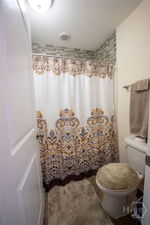 66 Tarbert Cut Cut, Richmond Hill, GA 31324 - full bath featuring toilet and a shower with shower curtain