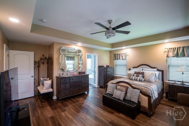 66 Tarbert Cut Cut, Richmond Hill, GA 31324 - bedroom featuring dark wood finished floors, a tray ceiling, ceiling fan, and baseboards