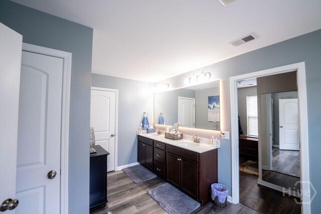 66 Tarbert Cut Cut, Richmond Hill, GA 31324 - full bathroom with wood finished floors, double vanity, and baseboards