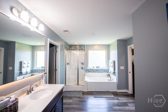 66 Tarbert Cut Cut, Richmond Hill, GA 31324 - full bath with plenty of natural light, a stall shower, vanity, and a garden tub