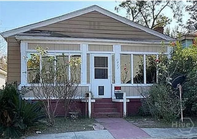 1011 Richards St, Savannah, GA 31415 - bungalow-style house featuring a sunroom