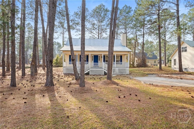 800 N Taylor Ct, Statesboro, GA 30461 - view of front of home with covered porch, a chimney, and metal roof