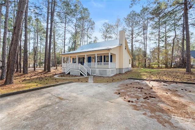 800 N Taylor Ct, Statesboro, GA 30461 - view of front of property featuring covered porch, metal roof, a chimney, and stairway