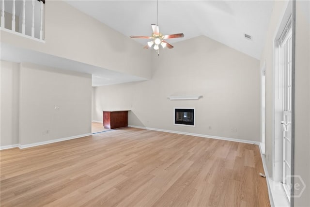800 N Taylor Ct, Statesboro, GA 30461 - unfurnished living room featuring a ceiling fan, a glass covered fireplace, light wood-style flooring, high vaulted ceiling, and baseboards