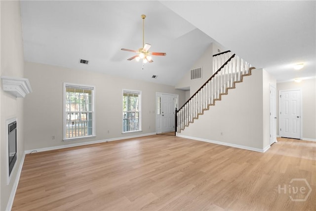 800 N Taylor Ct, Statesboro, GA 30461 - unfurnished living room with stairs, ceiling fan, light wood-type flooring, baseboards, and high vaulted ceiling